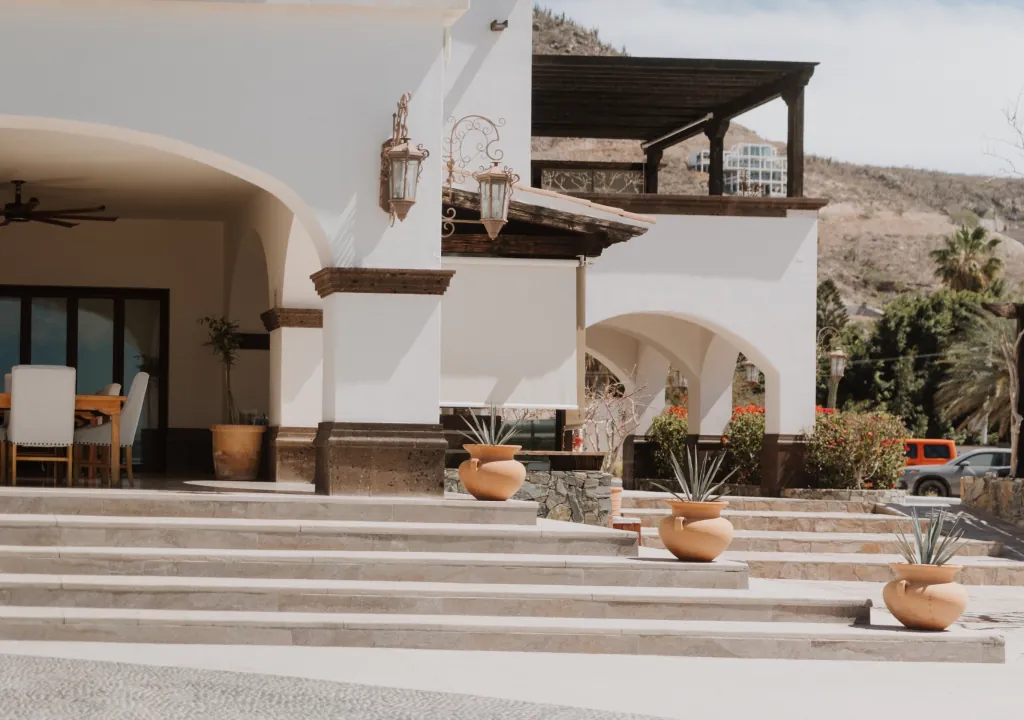 The entrance stairway to the house, lined with clay pots of agave