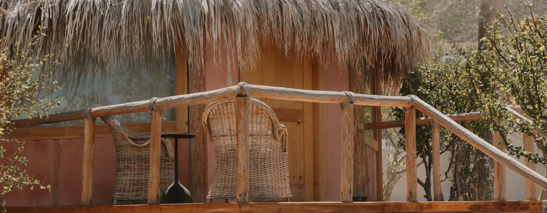 Palm and timber bungalow on a deck, among endemic plants