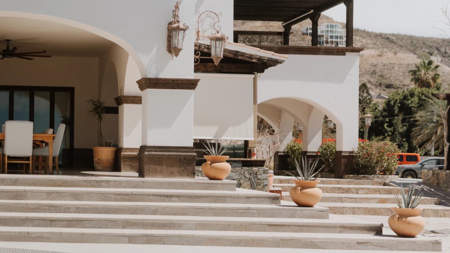 The entrance stairway to the house, lined with clay pots of agave