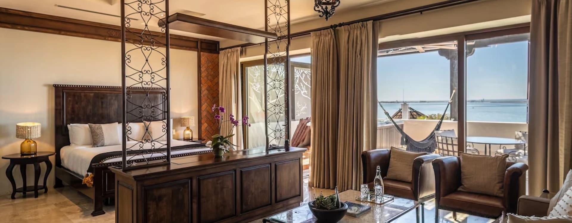 Sitting room with timber beams, a hanging lantern and a sea view